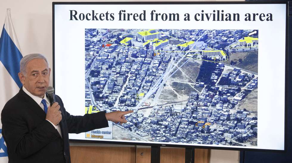 epa09211296 Israeli Prime Minister Benjamin Netanyahu gestures as he shows a slideshow during a briefing to ambassadors to Israel at the Hakirya military base in Tel Aviv, Israel, 19 May 2021. In response to days of violent confrontations between Israeli security forces and Palestinians in Jerusalem, various Palestinian militant factions in Gaza launched rocket attacks since 10 May that killed at least 12 Israelis to date. The Palestinian health ministry said that at least 213 Palestinians, including 61 children, were killed in the retaliatory Israeli airstrikes.  EPA/SEBASTIAN SCHEINER / POOL