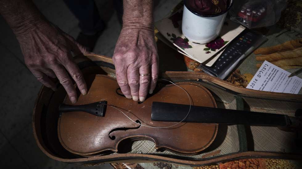 epa08147005 Hanoch Shacher, a Holocaust survivor born in Czech in 1935, survivor of the Theresienstadt concentration camp in what is now the Czech Republic and moved to Israel in 1949, holds his violin that he carried form Theresienstadt concentration camp, in northern city of Tzfat, Israel, 11 March 2019 (Issued 21 January 2020). At the invitation of the President of the State of Israel, 46 members of royalty, presidents, prime ministers, and parliamentary leaders from Europe, North America, and Australia will attend the Fifth World Holocaust Forum on 23 January 2020, Marking the 75th anniversary of the liberation of Auschwitz-Birkenau, in the holocaust museum of Yad Vashem in Jerusalem, Israel.  EPA/ATEF SAFADI