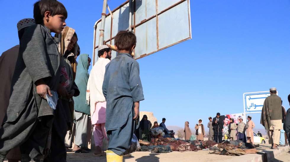 epa08854002 People gather beside the bodies of suspected Taliban, after they were killed in an airstrike overnight, in Kandahar, Afghanistan, 01 December 2020. At least 92 Taliban insurgents were killed in an airstrike by Afghan and foreign forces in Kandahar&#039;s Dand district on 30 November.  EPA/MUHAMMAD SADIQ