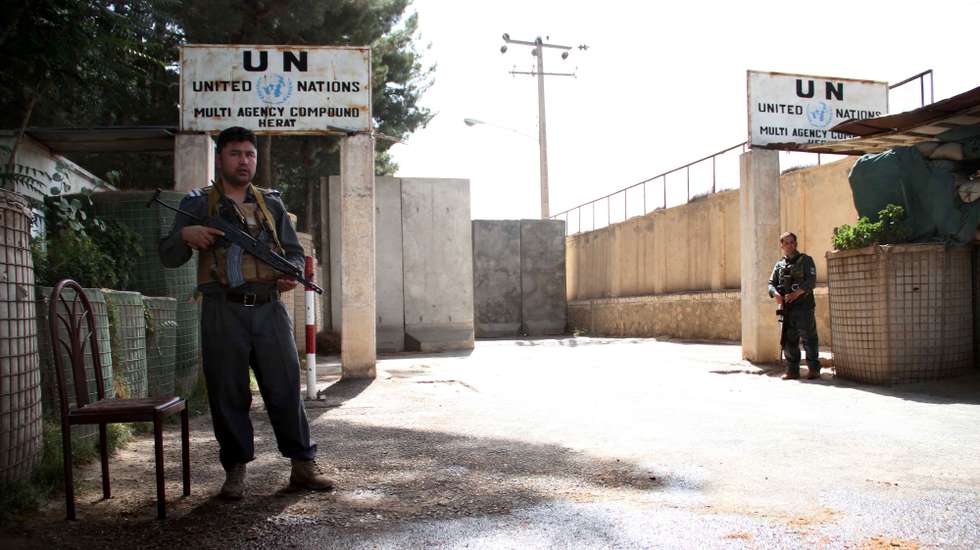 epa09381769 Afghan security officials stand guard outside the UN office in Herat, Afghanistan, 31 July 2021. The United Nations office in Afghanistan's western Herat province was attacked by "anti-government elements" on 30 July, who killed one Afghan security guard while many officials have been injured, the organization reported. The area where the UN compound is situated in Herat witnessed intense fighting between the Taliban and Afghan security forces on 30 July.  EPA/JALIL REZAYEE