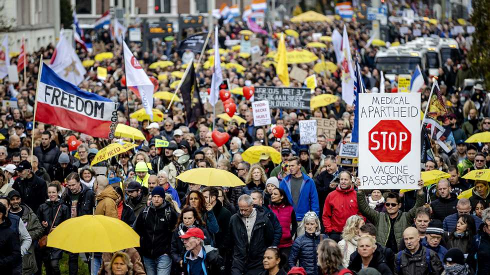 epa09569754 Opponents of the coronavirus measures take part in a protest march through the center of The Hague during the Together for the Netherlands manifestation in the Hague, the Netherlands, 07 November 2021.  EPA/ROBIN VAN LONKHUIJSEN