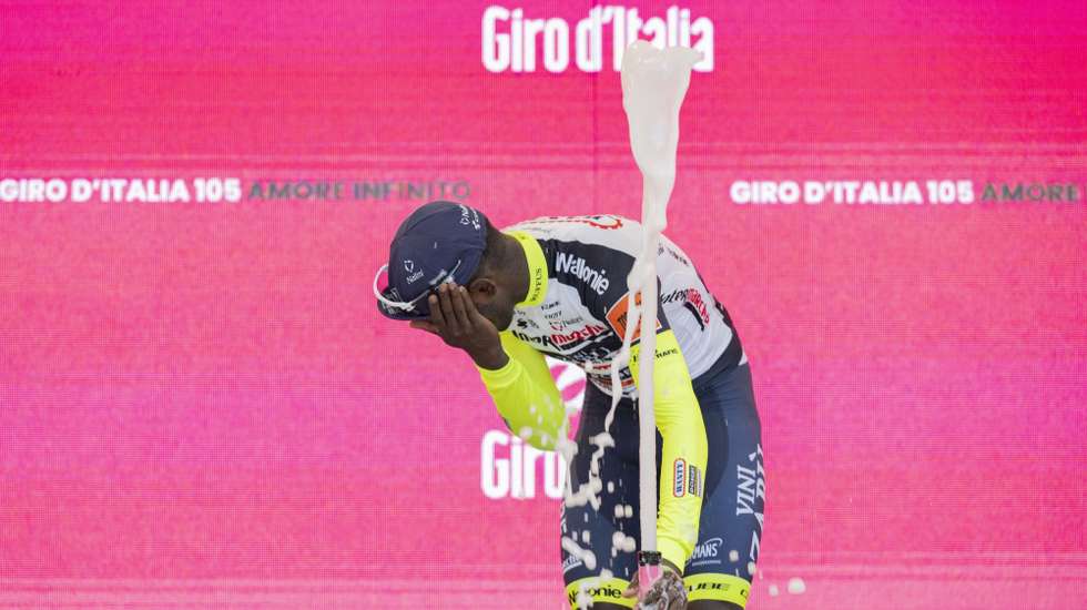 epa09953249 Eritrean rider Biniam Girmay  of Team Intermarche-Wanty-Gobert Materiaux celebrates on the podium after winning the 10th stage of the Giro d'Italia 2022 cycling race, over 196km between Pescara and Jesi, central Italy, 17 May 2022.  EPA/MAURIZIO BRAMBATTI