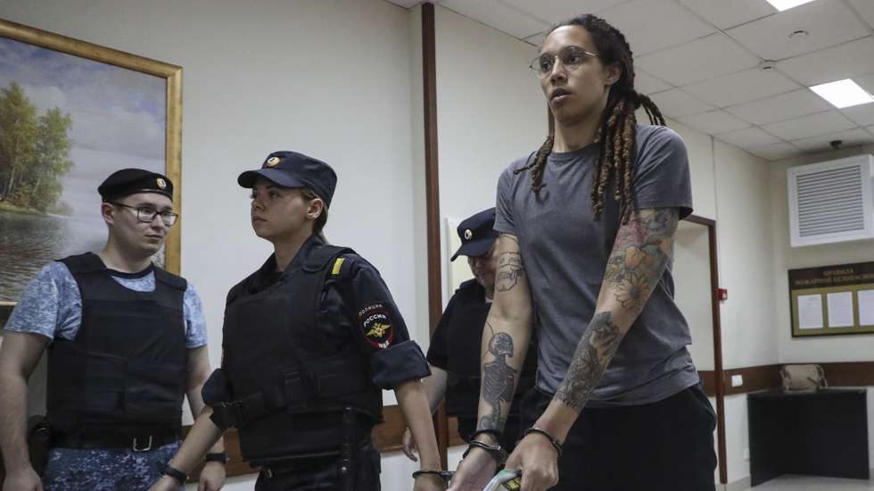 epa10105913 Two-time Olympic gold medalist and WNBA player Brittney Griner (C) is escorted to hear the court's verdict in Khimki City court in Khimki outside Moscow, Russia, 04 August 2022. The Khimki City Court has sentenced Griner to nine years in prison after finding her guilty on charges of drug smuggling.  EPA/MAXIM SHIPENKOV
