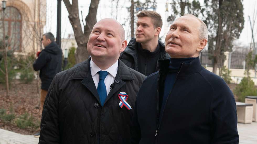 epa10530937 A handout photo made available by the Russian Presidential Press Office shows Russian President Vladimir Putin (R) and Sevastopol Governor Mikhail Razvozhayev (L) visit a children's arts-and-crafts centre, part of Chersonesos Taurica historical and archeological park on the ninth anniversary of Russia's annexation of Crimea, in Sevastopol, Crimea, 18 March 2023. Russia in 2014 annexed the Black Sea peninsula, shortly after Crimeans voted in a disputed referendum to secede from Ukraine. Russia declared the annexation of Crimea on 18 March 2014, two days tafter Crimeans voted in a disputed referendum to secede from Ukraine. The United Nations General Assembly in the Resolution 68/262 condemned the referendum in Crimea stating it had 'no validity'. Since 2015, Russia marks the 'Day of Reunification of Crimea with Russia' as a holiday annually on 18 March.  EPA/Russian Presidential Press Office / HANDOUT MANDATORY CREDIT HANDOUT EDITORIAL USE ONLY/NO SALES