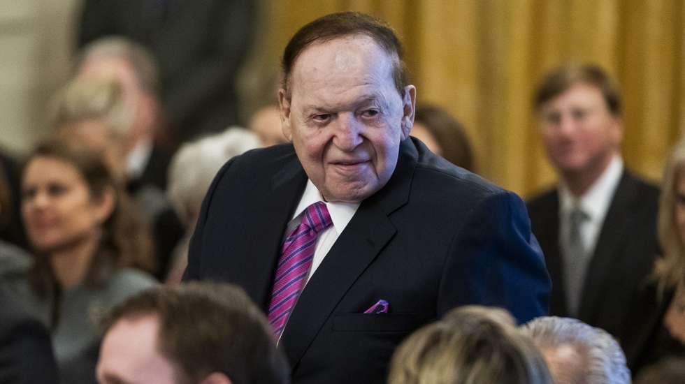 epa07171214 Casino magnate Sheldon Adelson waits for US President Donald J. Trump to award the Presidential Medal of Freedom to his wife, Dr. Miriam Adelson, in the East Room of the White House in Washington, DC, USA, 16 November 2018. The medal is the nation's highest civilian honor, and awarded at the discretion of the President.  EPA/JIM LO SCALZO