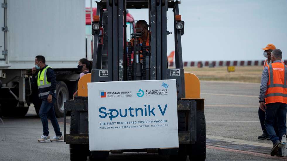 epa09010654 Airport personnel unload the boxes with the Sputnik V vaccines at the Maiquetia International Airport, near Caracas, Venezuela, 13 February 2021. A first batch of the Russian Sputnik V vaccine against covid-19 arrived on 13 February at the MaiquetÃ­a International Airport, which serves Caracas, on a plane from Moscow of the Venezuelan state airline Conviasa, as part of the contract established between Venezuela and Russia for ten million doses.  EPA/RAYNER PEÃ‘A R