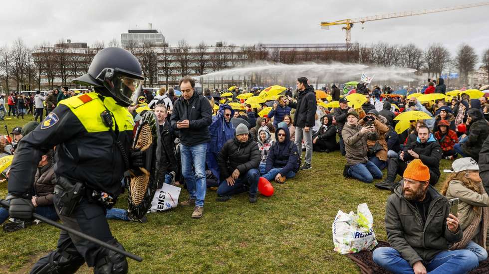 epa09074024 Police officers try to disperse anti-lockdown protesters at the Malieveld in The Hague, The Netherlands, 14 March 2021. After protesting for weeks against coronavirus measures, demonstrators ended their protests in The Hague.  EPA/ROBIN VAN LONKHUIJSEN