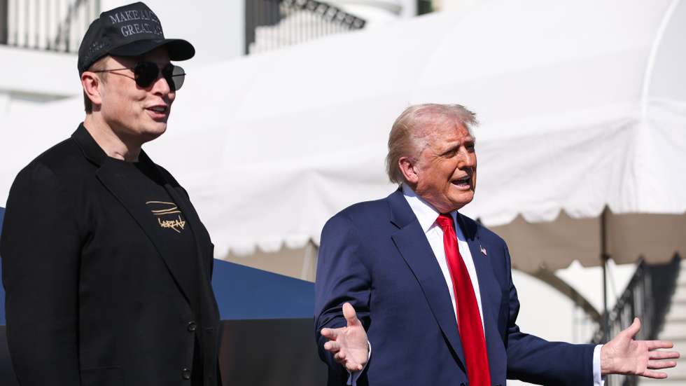 epa11956958 Tesla CEO and Senior Advisor to the President of the United States Elon Musk (L) looks on as US President Donald Trump (R) speaks in front of Tesla vehicles at the White House in Washington, D.C., USA, 11 March 2025. President Trump has said he will buy a Tesla to support Tesla and Elon Musk after recent attacks on Tesla charging stations and calls for boycotts of Tesla products.  EPA/SAMUEL CORUM / POOL
