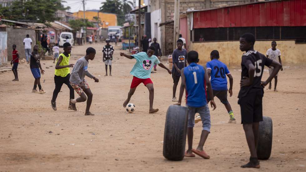Crianças jogam à bola, durante uma reportagem da agência Lusa no bairro do Sambizanga, dias após da visita do Papa Leão XIV a Angola, em Luanda, Angola, 22 de abril de 2026. No Sambizanga, bairro de Nagrelha e Bangão, Mantorras e William Carvalho, Dádiva pousa na rua cor-de-rosa, a do mural que junta políticos como Neto e Savimbi, na Luanda dos contrastes, onde a pobreza se esconde atrás dos arranha-céus e se mostra sem vergonha nos musseques. (ACOMPANHA TEXTO DA LUSA DO DIA 27 DE ABRIL DE 2026). JOSÉ SENA GOULÃO/LUSA