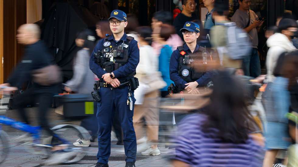 epa12604299 Taiwanese police officers keep watch at a busy shopping center near the crime scene of a knife attack in Taipei, Taiwan, 20 December 2025. President Lai Ching-te said the government will increase police presence, including rapid response teams, in crowded public areas to ensure quick action against threats, after a random smoke-grenade and knife attack in Taipei on 19 December that killed three and injured several others.  EPA/RITCHIE B. TONGO