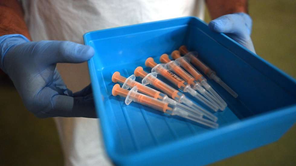 epa09029498 A pharmacist prepares the Oxford/AstraZeneca Covid19 vaccine at an NHS vaccination centre in Ealing, west London, Britain 22 February, 2021. Britain's Prime Minister Johnson has pledged that all adults in the UK will be offered a coronavirus jab by the end of July. Johnson is to announce his four-part plan to lift the UK coronavirus lockdown on 22 February 2021.  EPA/NEIL HALL