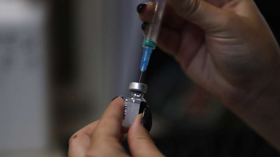 epa09421721 A nurse prepares to inject an Israeli woman  with the third shot of COVID-19 vaccine in Jerusalem,  20 August 2021. Israel has started to offer a third shot of covid vaccine to people aged over 40 as a measure to stop the spreading of the Delta variant.  EPA/ATEF SAFADI
