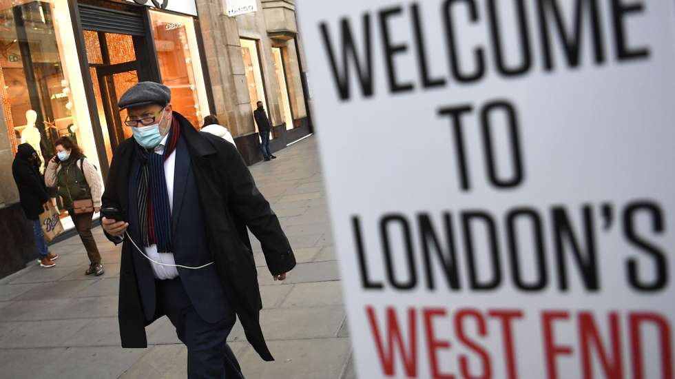 epa09631855 A shopper wears a mask in London, Britain, 09 December 2021. Britain's government has announced new Covid-19 rules, including working from home if possible. Starting Friday 10 December, face masks will be mandatory for most indoor public venues as well as on public transport.  EPA/NEIL HALL