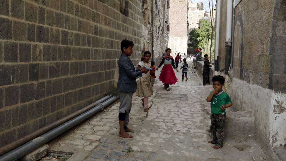 epa09223663 Yemeni children play at an alley in the old city of Sana’a, Yemen, 23 May 2021. The old city of Sana'a is one of the oldest continuously-inhabited cities in the world. It was inscribed by UNESCO on the World Heritage List in 1986. It is made up of more than 6,000 buildings including its distinctive multi-story tower houses.  EPA/YAHYA ARHAB