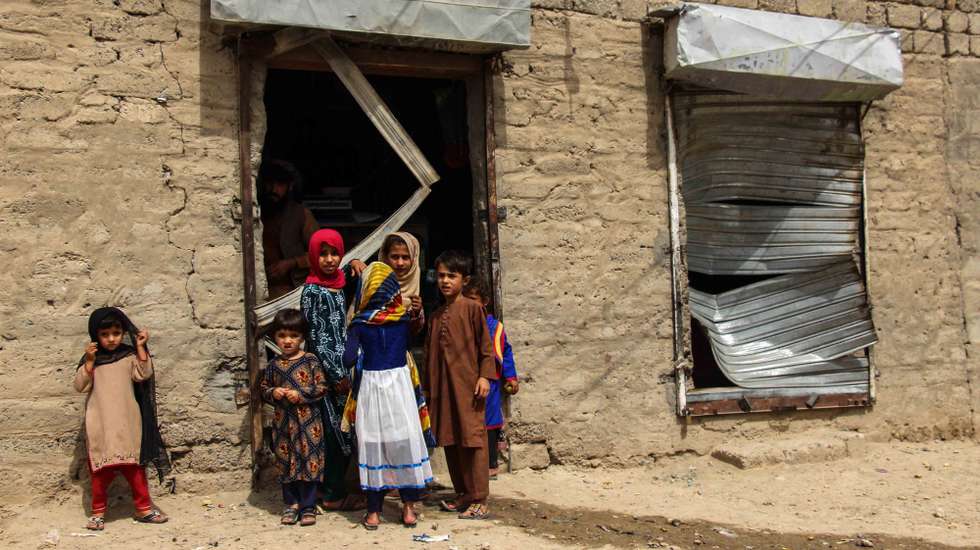 epa09325537 Children stand beside a shop that was damaged after a car bomb exploded nearby in Kandahar, Afghanistan, 06 July 2021. A car bomb exploded near a police center killing at least two police and injuring 24 others in Kandahar. The Taliban on 05 July said they planned to capture no Afghan provincial capital by military force even as its fighters continue making rapid territorial gains amid an ongoing withdrawal of foreign troops from the war-ravaged country. Violence in the country has spiked as representatives of the Afghan government and the Taliban try to resume the stalled intra-Afghan talks in Doha.  EPA/M SADIQ