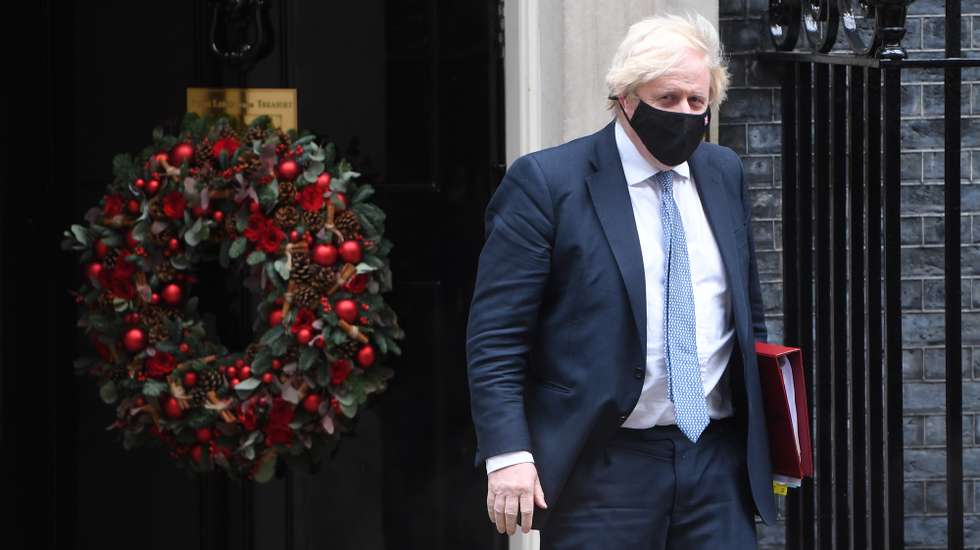 epa09629259 British Prime Minister Boris Johnson departs Downing Street to attend Prime Minister's Questions (PMQ) in London, Britain, 08 December 2021. Johnson faces questions amid allegations that Downing Street staff held a party during the Covid-19 lockdown on Christmas 2020.  EPA/NEIL HALL