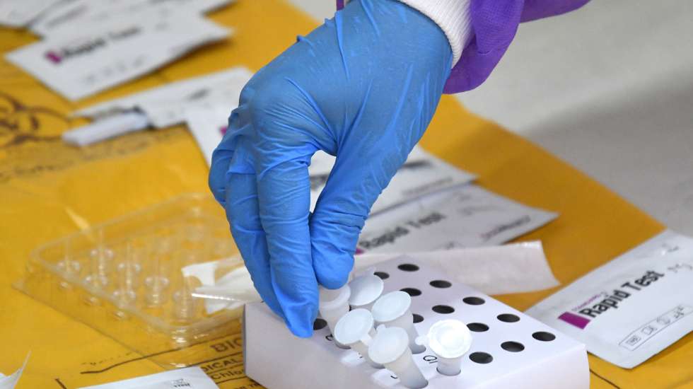 epa08495673 A medical lab technician collects swab samples  for coronavirus COVID-19 Rapid Antigen detection testing, in New Delhi, India, 19 June 2020. Countries around the world are taking measures to stem the widespread of the SARS-CoV-2 coronavirus which causes the COVID-19 disease.  EPA/STR