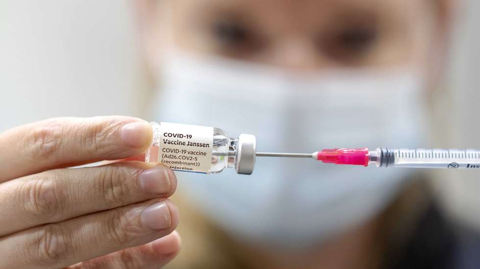 epa09300586 A health workers prepares a dose of the Janssen COVID-19 vaccine at a municipal health service (GGD) vaccination center in Nieuwegein, The Netherlands, 25 June 2021. The vaccine is especially popular among young people, because a single shot is enough for the vaccinated person.  EPA/SANDER KONING