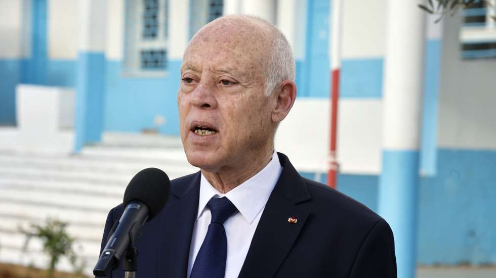 epa11042815 Tunisia's President Kais Saied speaks to the media after voting at a polling station during the local councils' elections, in Tunis, Tunisia, 24 December 2023. Tunisians will elect members of the local councils who will be called upon to form the National Council of Districts and Regions, second chamber of Parliament, created by the 2022 Constitution.  EPA/MOHAMED MESSARA