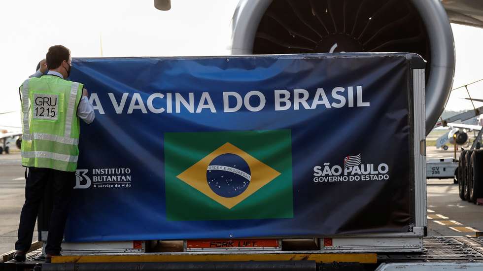 epa08858911 An airport's worker unloads the second shipment of 'coronavac' vaccine against COVID-19 upon its arrival upon its arrival at Guarulhos International Airport in Sao Paulo, Brazil, 03 December 2020. The 'coronavac' vaccine against COVID-19 is developed by Chinese Sinovac Lab and its final clinical tests are in its final stage.  EPA/Sebastiao Moreira