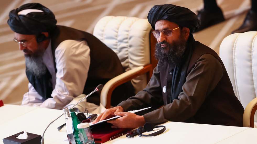 epa08663248 Taliban co-founder Mullah Abdul Ghani Baradar (R) speaks during the opening session of the peace talks between the Afghan government and the Taliban  in Doha, Qatar, 12 September 2020. The United States, Taliban and Afghanistan government delegations officially began the intra-Afghan negotiations on 12 September 2020.  EPA/STRINGER