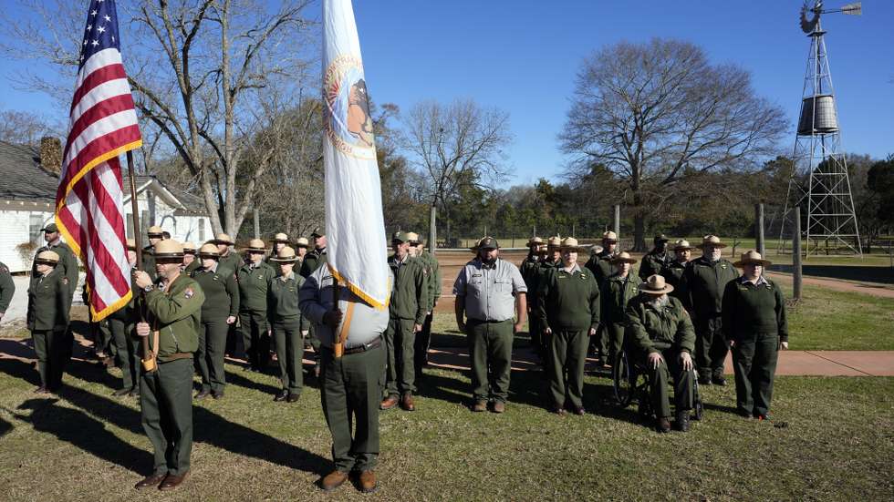 epa11805728 Members of the National Park Service watch as the hearse containing the casket of former US President Jimmy Carter arrives at the Jimmy Carter Boyhood Farm, as part of his funeral ceremony in Archery, Georgia, USA, 04 January 2025. Carter, who was the oldest-lived former US president, died at age 100 in his hometown of Plains, Georgia, surrounded by his family 29 December 2024.  EPA/ALEX BRANDON / POOL