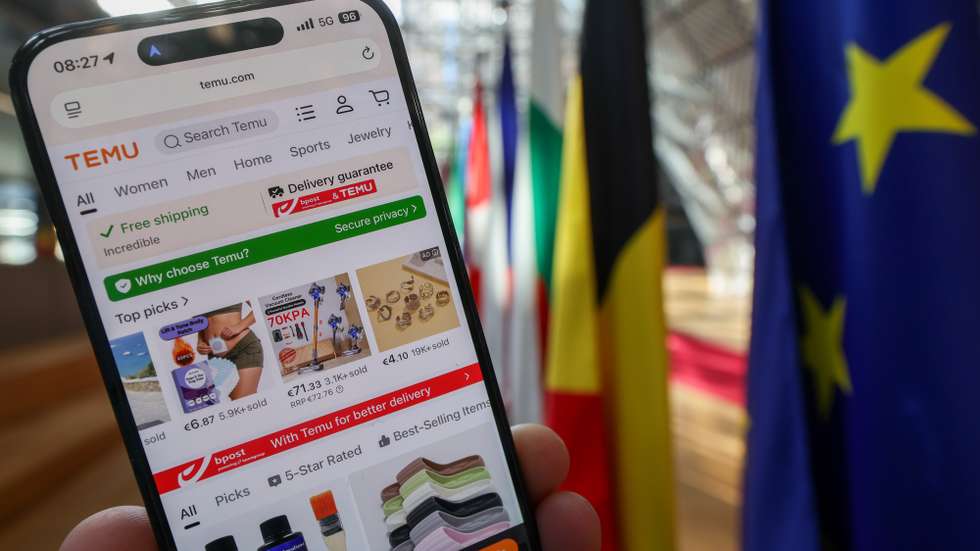 epa12999478 (ILLUSTRATION) - The Chinese online marketplace Temu is displayed on a smartphone screen in front of European Union flags at the European Council headquarters in Brussels, Belgium, 28 May 2026. The European Commission is increasing scrutiny on online platforms such as Temu over alleged breaches of EU digital, consumer protection, and data privacy rules, including concerns linked to unsafe products, manipulative online practices, and the use of personal data.  EPA/OLIVIER HOSLET