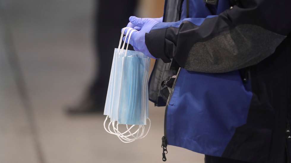 epa08359970 A local police hands in facial masks to commuters at Atocha train station in Madrid, Spain, 13 April 2020. Many people from various sectors return back to work as lockdown in Spain faces its fifth week in a bid to slow down the spread of the pandemic COVID-19 disease caused by the SARS-CoV-2.  EPA/JUANJO MARTIN