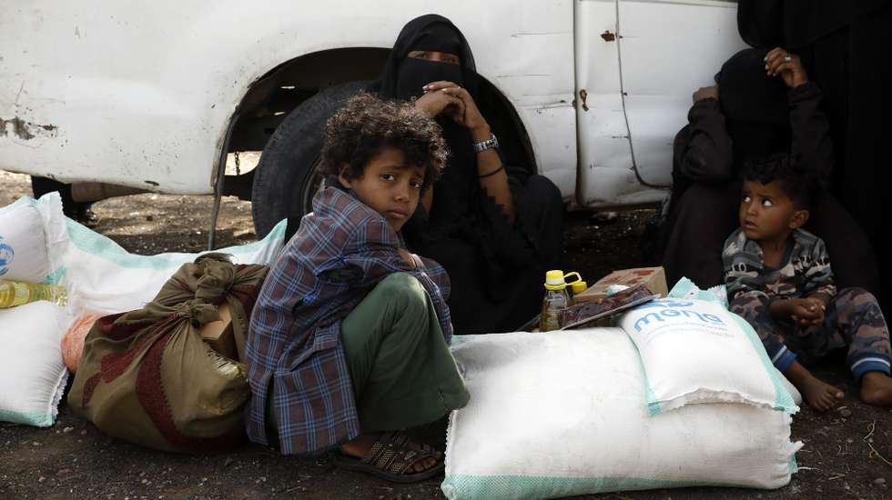 epa09919537 Displaced Yemenis get emergency food aid provided by Mona relief agency amid a heightened food insecurity, at a camp for Internally Displaced Persons (IDPs) on the outskirts of Sana'a, Yemen, 29 April 2022 (issued 30 April 2022). Aid agencies working in Yemen released on 30 April 2022 the 2022 Yemen Humanitarian Response Plan (HRP), seeking nearly 4.3 billion US dollar to target 17.3 million out of the 23.4 million people in need of lifesaving humanitarian assistance and protection services, after international donors in March 2022 pledged 1.3 billion US dollar â€“ 30 percent of the total requirement for the 2022 HRP. The United Nations ranks Yemen as the worst humanitarian crisis in the world with an estimated 80 percent of its 30 million-population are reliant on humanitarian aid for survival now. The UN estimated that around 161,000 people are likely to experience famine in 2022 and an additional 1.6 million are expected to fall into emergency levels of hunger after the aid agencies suspended vital relief programs in impoverished Yemen as of January 2022 due to severe funding shortfalls.  EPA/YAHYA ARHAB