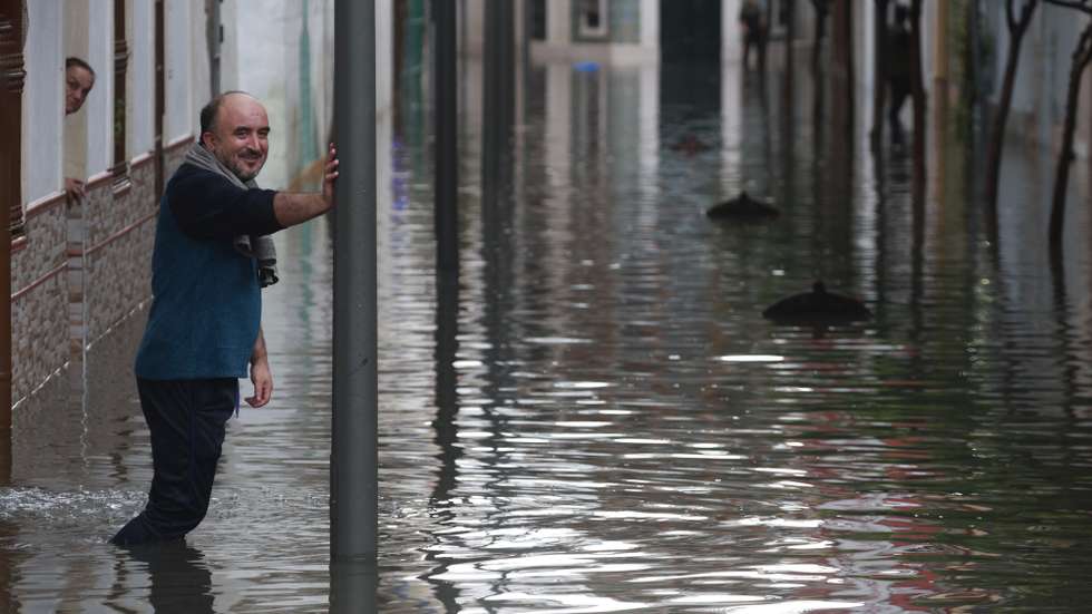 epa13313479 A resident looks at a flooded street after heavy rainfall that hit the area early in the morning, in the town of Algeciras, southern Spain, 18 October 2026.  EPA/A.Carrasco Ragel