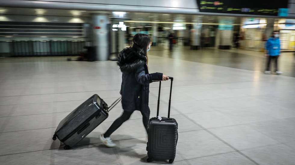 A passenger passes by the departure terminal of Lisbon airport, Lisbon, Portugal, February 1, 2021. Portugal has extended until 14th February the restrictive measures concerning air traffic from outside the European Union (EU) and the Schengen Area, which remains limited to "essential travel" and subject to a negative prior test to covid-19.  MIGUEL A. LOPES/LUSA