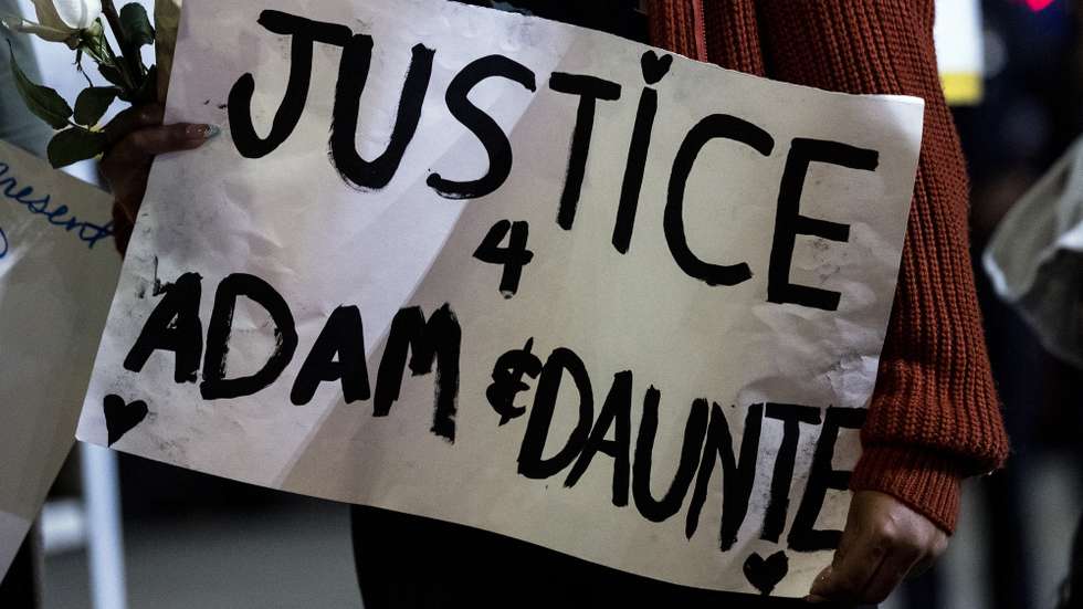 epa09144487 A demonstrator holds a poster reading 'Justice for Adam and Daunte' during a candlelight vigil and rally for Daunte Wright and Adam Toledo at Leimert Park Plaza, in Los Angeles, California, USA, 18 April 2021. 20 year old Daunte Demetrius Wright was fatally shot by police officer Kimberly Ann Potter in Brooklyn Center, Minnesota on April 11, 2021. On March 29, 2021, 13 year old Adam Toledo was shot and killed by police officer Eric Stillman in the Little Village neighborhood on the West Side of Chicago on March 29, 2021.  EPA/ETIENNE LAURENT