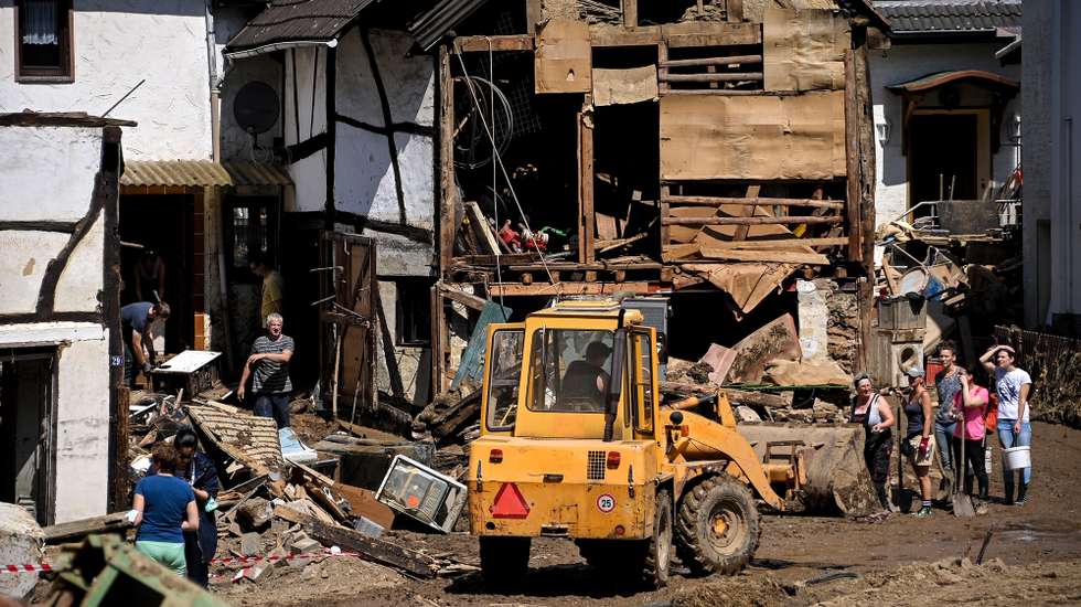 epaselect epa09351796 Residents of the Rhineland-Palatinate village of Schuld clear debris out of the way after the flooding of the Ahr River, in Schuld, Germany, 18 July 2021. Large parts of Western Germany were hit by heavy, continuous rain in the night to Wednesday, resulting in local flash floods that destroyed buildings and swept away cars. With nearly 100 people now confirmed dead in Rhineland-Palatinate, the total number of victims in the flood disaster in western Germany rises to at least 155, with many hundreds still missing.  EPA/SASCHA STEINBACH