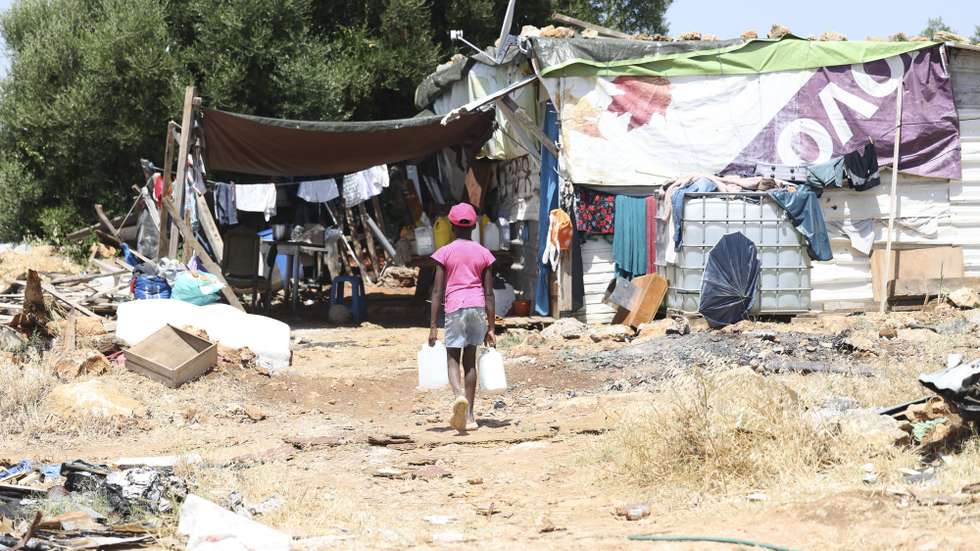 Um jovem carrega garrafões com água no Bairro do Talude Militar, em Loures, 10 de julho de 2026. (ACOMPANHA TEXTO DA LUSA DO DIA 14 DE JULHO DE 2026). ANTÓNIO COTRIM/LUSA