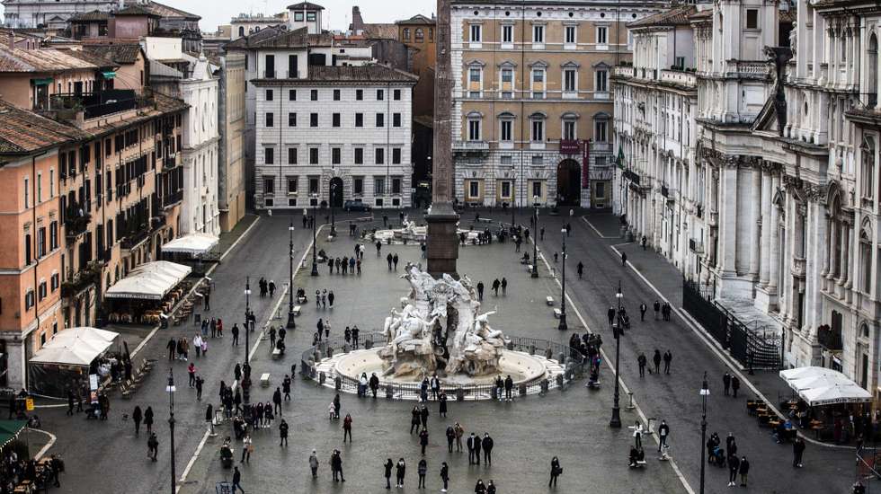 epa09059960 People listen to guitarist Jacopo Mastrangelo (unseen) playing from a terrace on Piazza Navona in Rome, Italy, 07 March 2021.  EPA/ANGELO CARCONI