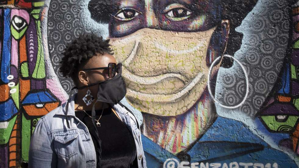 epaselect epa09440202 A local Soweto resident stands in front of an informative graffiti art work educating local Soweto residents about the dangers of the Covid-19 Corona virus, Johannesburg, South Africa, 01 September 2021. local scientists are monitoring the C.1.2 variant as a variant of interest as it has spread across South Africa, but has been detected at low frequency. To date there are around 100 sequences of C.1.2 reported globally since the variant was first detected in South Africa in May this year.  EPA/KIM LUDBROOK