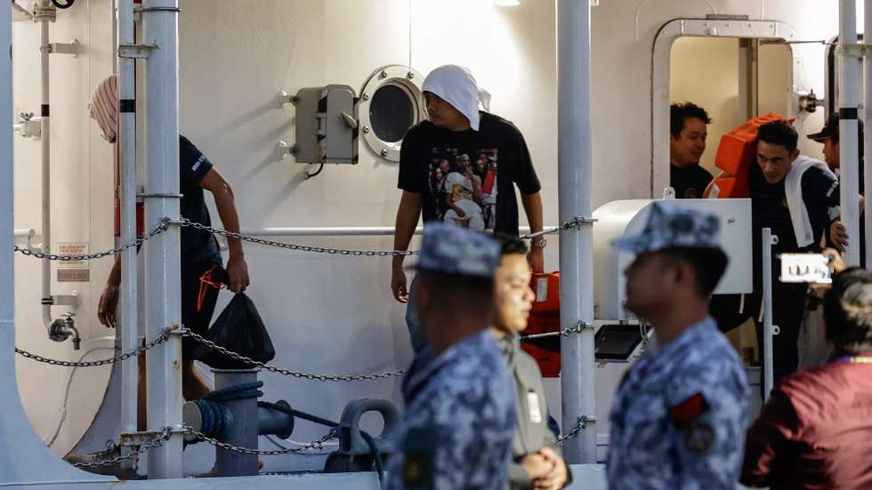 epa12681368 Filipino crew members of the cargo ship M/V Devon Bay disembark from a Philippine Coast Guard (PCG) vessel at the port of Manila, Philippines. 26 January 2026. The PCG on 25 January received custody of 15 ship crew who survived and the remains of two who died after Chinese Coast Guard units pulled the Filipinos from disputed waters of the South China Sea after the M/V Devon Bay reportedly capsized on 23 January.  EPA/ROLEX DELA PENA