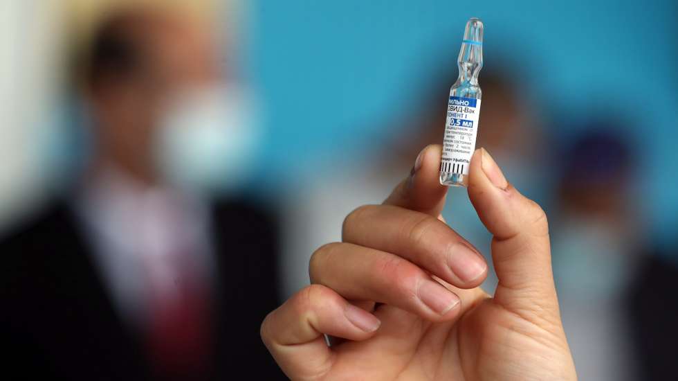 epa09071317 A Tunisian nurse shows a vial of the Russian Sputnik V vaccine against COVID-19 at a hospital in Tunis, Tunisia, at the launch of a vaccination program, 13 March 2021. Tunisia has received 30,000 doses of Russia's COVID-19 vaccine, Sputnik V. Health workers are a priority for vaccination.  EPA/MOHAMED MESSARA