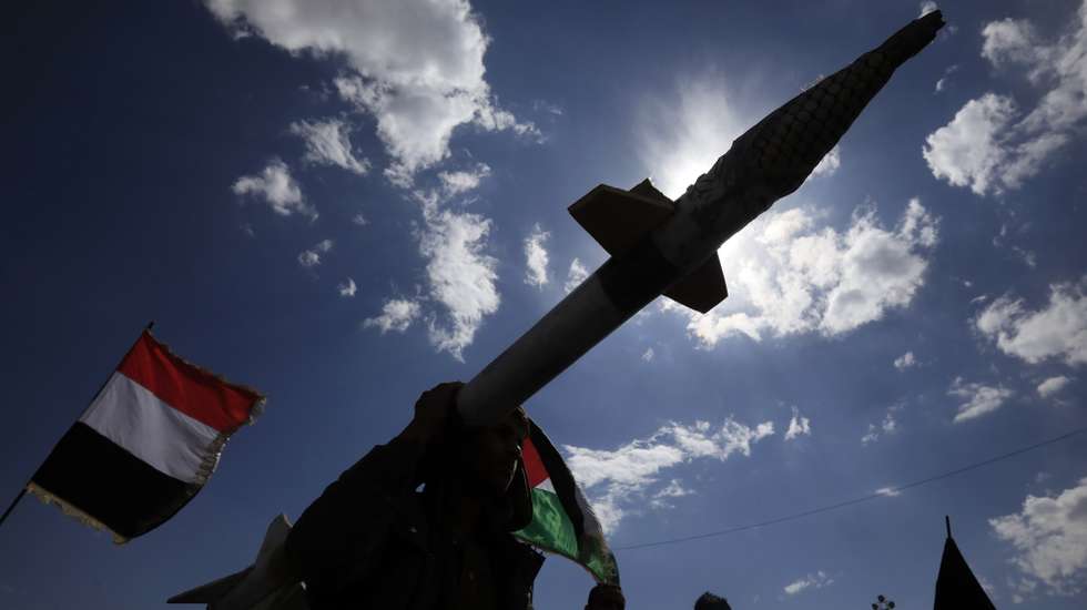 epaselect epa11970462 A Houthi supporter carries a mock missile as others wave the flags of Palestine (R) and Yemen (L) during a protest in Sana'a, Yemen, 17 March 2025 against US airstrikes on Houthi positions. Houthi supporters have taken to the streets of Sana'a to protest the airstrikes that targeted Houthi-held positions in several Yemeni cities on 15 March. The Houthis have vowed to target US ships in the Red Sea in retaliation for the recent US airstrikes that killed at least 53 people and wounded 98 others, according to a statement by Houthi military spokesman Yahya Sarea.  EPA/YAHYA ARHAB