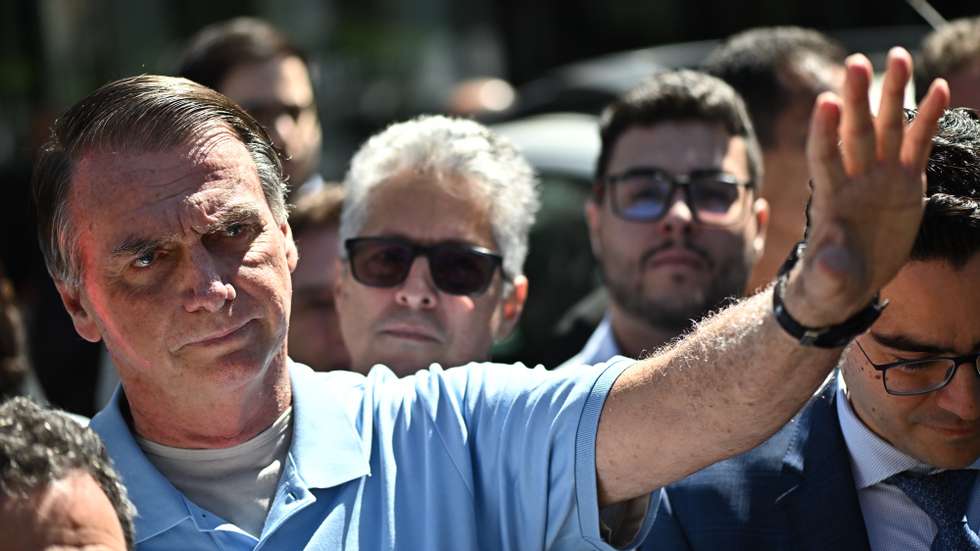 epa12073343 Brazil's former president, Jair Bolsonaro, waves as he leaves the DF Star Hospital in Brasilia, Brazil, 04 May 2025. Bolsonaro was discharged from the hospital where he was hospitalized for three weeks after undergoing surgery for a serious intestinal occlusion.  EPA/Andre Borges