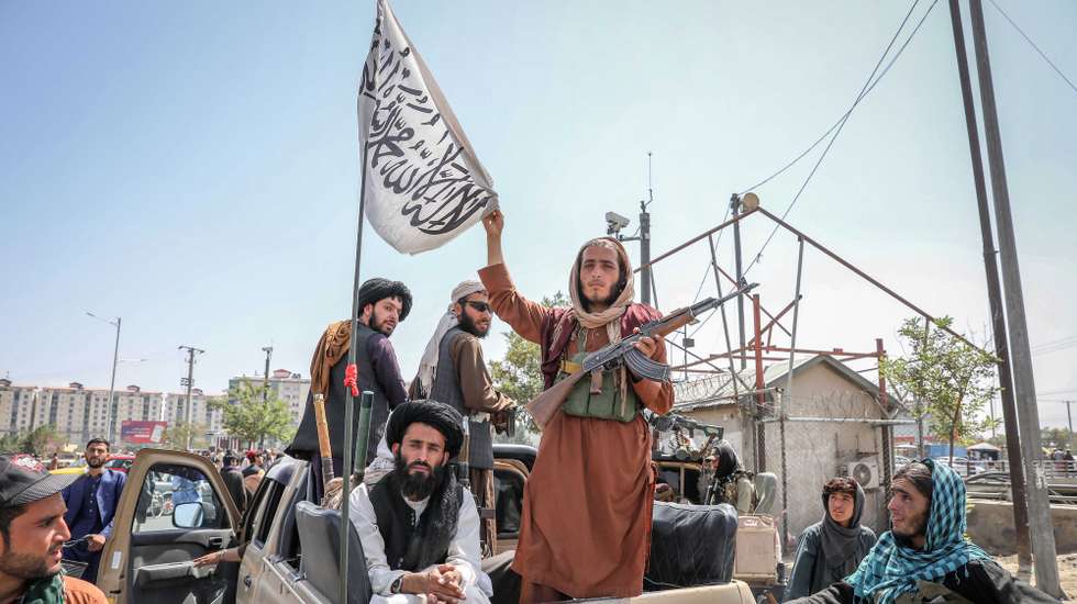 epa09416519 Taliban fighters are seen on the back of a vehicle in Kabul, Afghanistan, 16 August 2021. Taliban co-founder Abdul Ghani Baradar, on 16 August 2021, declared victory and an end to the decades-long war in Afghanistan, a day after the insurgents entered Kabul to take control of the country. Baradar, who heads the Taliban political office in Qatar, released a short video message after President Ashraf Ghani fled and conceded that the insurgents had won the 20-year war.  EPA/STRINGER