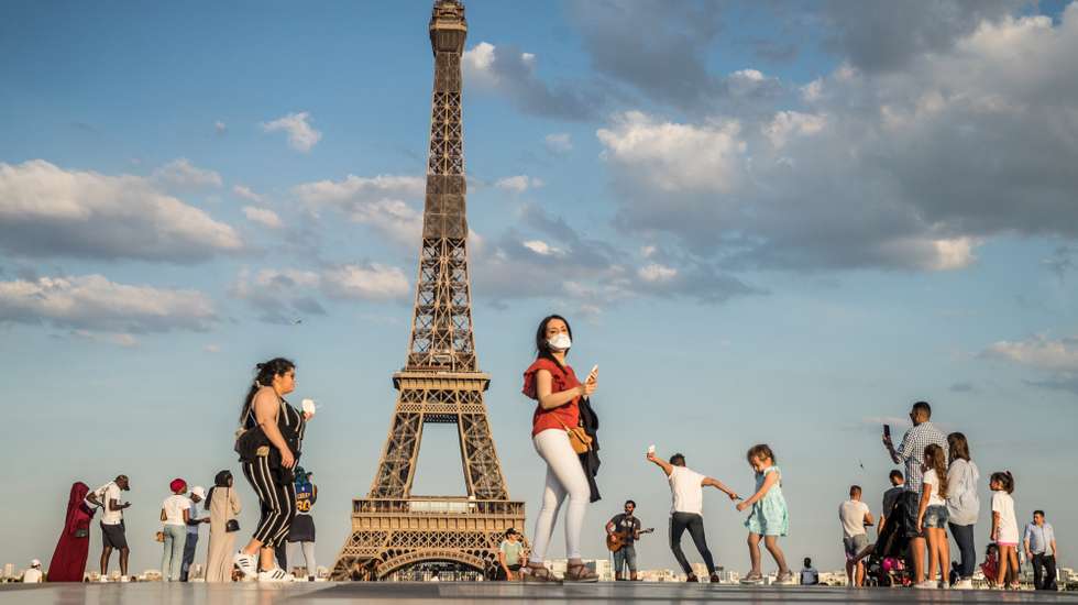 epa08461746 People dance to music at the Trocadero Human Rights Plaza near the Eiffel Tower in Paris, France, 02 June 2020. France has started a gradual lifting of COVID-19 lockdown restrictions in an effort to restart its economy and help people get back to their daily routines. The country reopened its bars and restaurants after two months of nationwide restrictions due to the coronavirus outbreak.  EPA/MOHAMMED BADRA