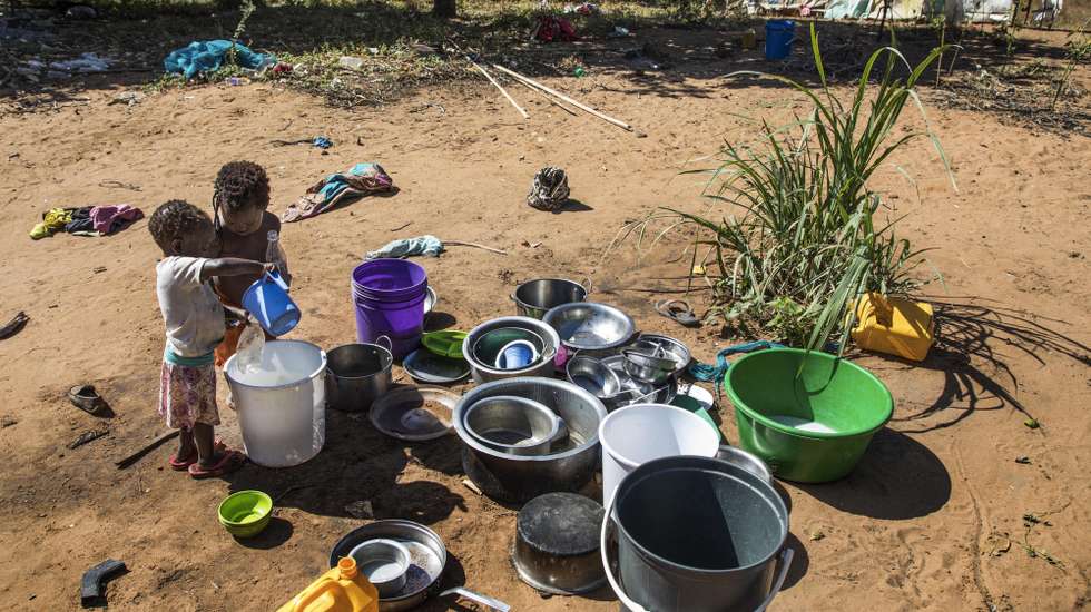 epa08560087 Children from the Vicente Tiago family of 30 people who fled the armed attacks in Muidumbe, Cabo Delgado, and took refuge in a small precarious house in Chiuba, Pemba City, Cabo Delgado province, Mozambique, 21 July 2020 (issued 22 July 2020). It is one of thousands of families in need of food aid in the humanitarian crisis affecting the northern province of Mozambique.  EPA/RICARDO FRANCO