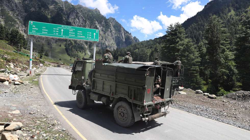 epa08658802 Indian army vehicles move along a highway leading to Ladakh, at Gagangeer some 81 kilometers from Srinagar, the summer capital of Indian Kashmir, 07 September 2020 (issued 10 September 2020). Apart from nomadic families with goats, sheep and horses, no one is allowed to travel along the normally bustling mountain road to allow the Indian military to operate freely amid a months-long standoff between India and China along the disputed border in eastern Ladakh.  EPA/FAROOQ KHAN