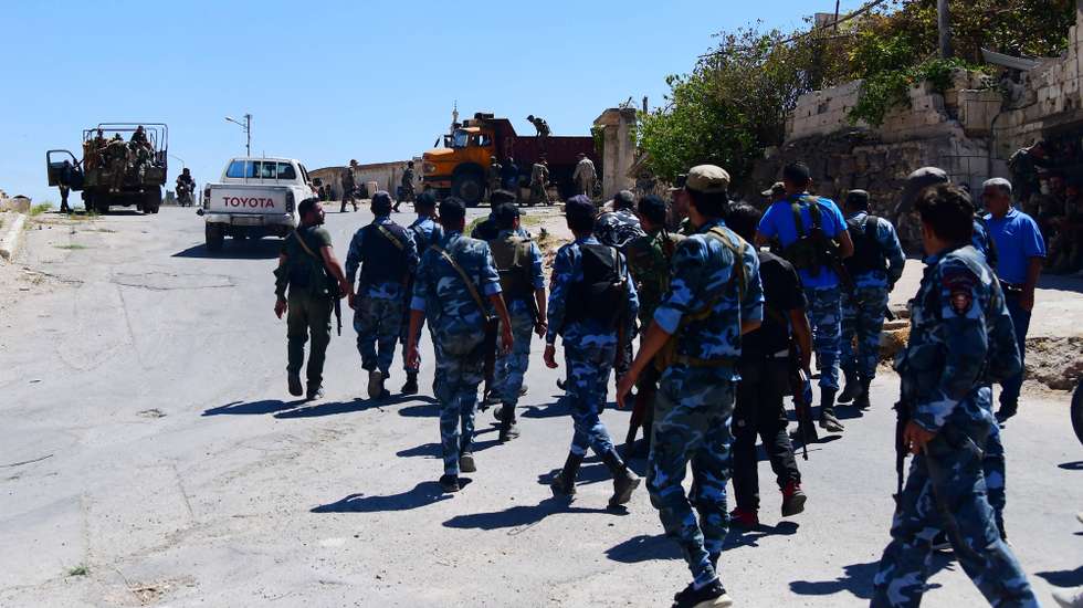 epa09456182 A handout photo made available by the Syrian Arab News Agency (SANA) showing Syrian troops deploying in the rebels-held Daraa al-Balad, in Daraa province in southern Syria, 08 September 2021, as part of the implementation of the settlement agreement reached between the Syrian state and the militants. The agreement provides for the exit of the militants to the north, settling of their legal status, and handing over their weapons.  EPA/SANA HANDOUT  HANDOUT EDITORIAL USE ONLY/NO SALES