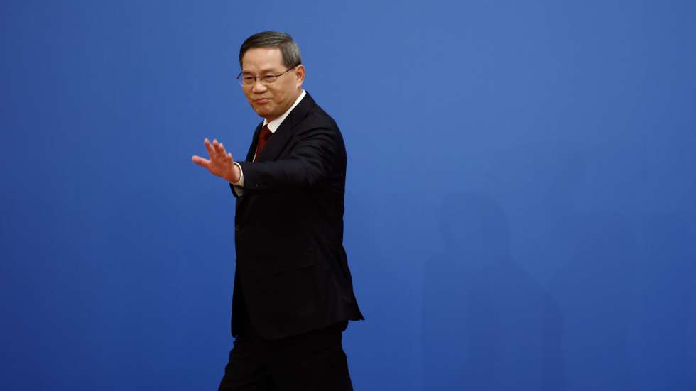 epa10519501 Chinese Premier Li Qiang waves as he leaves a news conference following the closing session of the National People's Congress (NPC), at the Great Hall of the People, in Beijing, China, 13 March 2023.  EPA/FLORENCE LO / POOL
