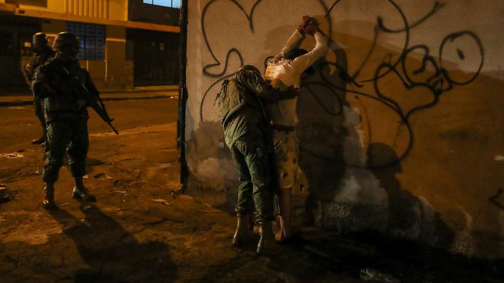 epa11075639 Ecuadorian soldiers pat down a man during an operation to control and search for weapons and to enforce the curfew in Quito, Ecuador, 14 January 2024. Ecuador's President Daniel Noboa, following the attacks and violent acts that occurred on 09 January in the country, decreed a state of emergency, declared the existence of an internal armed conflict, and ordered the Public Force to carry out security and control operations in different locations in Ecuador.  EPA/Jose Jacome
