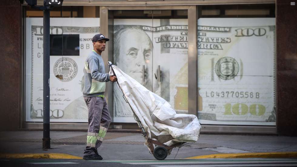epa12003704 A person walks past a currency exchange office in Buenos Aires, Argentina, 01 April 2024. Argentina is a de facto bimonetary economy, in which, although there is its own currency, the price of the US dollar determines the daily decisions of investors, businesses, and families an obsession forged in the heat of the South American country's recurring financial crises.  EPA/Juan Ignacio Roncoroni