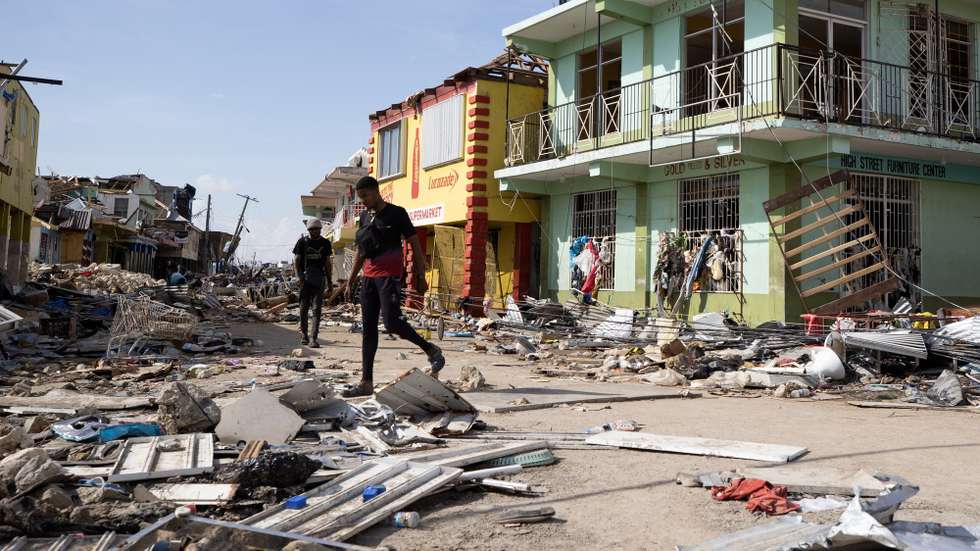 epaselect epa12496492 People walk along a street destroyed by Hurricane Melissa in Black River, Jamaica, 31 October 2025. More than 50 people have died in the Caribbean as a result of the hurricane, mainly in Haiti and Jamaica, where rescue teams are struggling to reach the most severely affected and isolated areas.  EPA/ORLANDO BARRIA