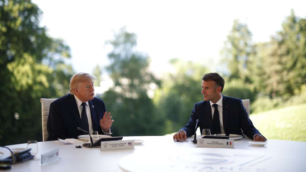 epa13039738 French President Emmanuel Macron (R) and US President Donald Trump (L) attend a working dinner at the Hotel Royal during the G7 summit in Evian-les-Bains, France, 15 June 2026. The 52nd G7 Summit takes place in Evian-les-Bains from 15 to 17 June 2026.  EPA/YOAN VALAT